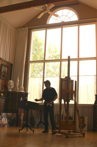 Thomas V. Nash painting at the easel in his studio
